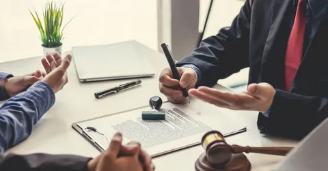 Homeowner meeting with North Carolina HOA lawyer to review fines, penalties, and legal rights for property protection.